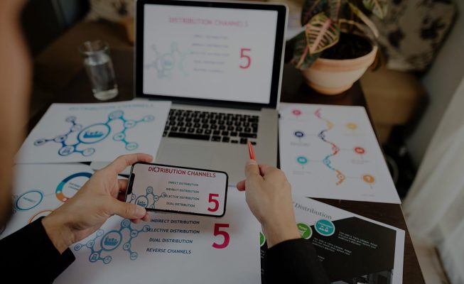 marketing product manager holding marketing promotion plan marketing product manager desk. Marketing mix plan for target market.